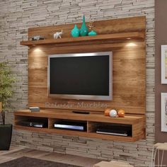 a living room with a large television mounted to the side of it's wall