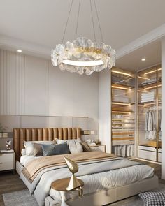 a bedroom with a large bed and a chandelier hanging from it's ceiling