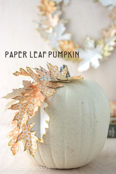 a paper leaf pumpkin sitting on top of a table