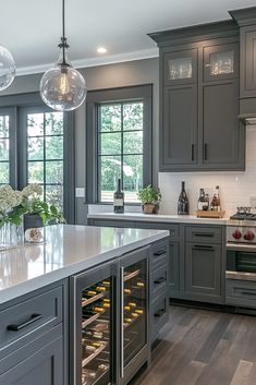 a kitchen filled with lots of gray cabinets and counter top space next to an oven