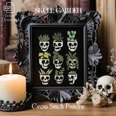 a cross stitch pattern with skulls and succulents in the middle, surrounded by candles