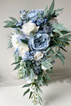 a bridal bouquet with blue and white flowers