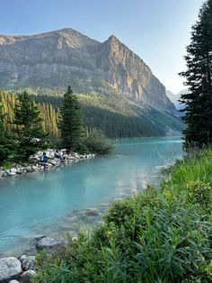 the water is blue and there are mountains in the background