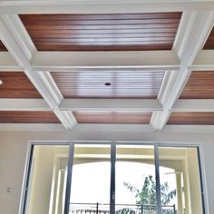 the ceiling in this living room is painted white and has wood trimming on it