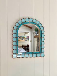 a mirror hanging on the side of a wall