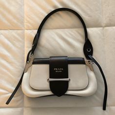 Authentic Prada Black And White Leather Only Used 2-3 Times Comes With 2 Straps - Short Strap And Longer Strap ***Please Note There Are Stains From The Front Flap That Shuts The Purse. See Photos *** Black Outfit White Bag, Black And White Purse Outfit, White Designer Bag Outfit, Black And White Bag Outfit, White Luxury Bag, White Shoulder Bag Outfit, Prada Sidonie Bag, Vintage Bag Aesthetic, Designer Bags Aesthetic