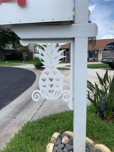 a white sign sitting on the side of a road