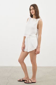 Looking for a genuine super soft and everyday top? Designed in a light silhouette, sleeveless Mia Side Ties Top White can be worn with ease all summer long and compliments most body types with adjustable side-ties. - 100% Turkish double layered gauze cotton - Side slits tied with adjustable side-ties.- Crop top finish at waist Chic Tie-back Tank Top For Vacation, Chic Tops With Tie Waist For Vacation, Spring Vacation Tops With Tie Waist, Chic Tie Waist Tops For Vacation, Summer Vacation Tops With Tie Waist, Sleeveless Tie Back Blouse For Summer, Short Beachwear Tops For Summer, Summer Sleeveless Blouse With Tie Back, Tie Back Sleeveless Blouse For Summer