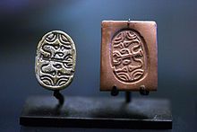 two different types of jewelry on display in front of a dark background, one is gold and the other is silver