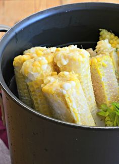 corn on the cob in a pot with herbs