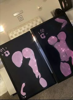 two black and pink art pieces on the floor