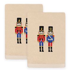 two hand towels with the image of a nutcracker and soldier in uniform on them