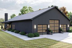 a black garage with two doors and three windows on the side of it, surrounded by grass