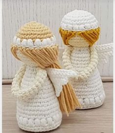 two crocheted snowmen standing next to each other