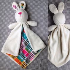 two stuffed animals laying next to each other on top of a bed covered in blankets