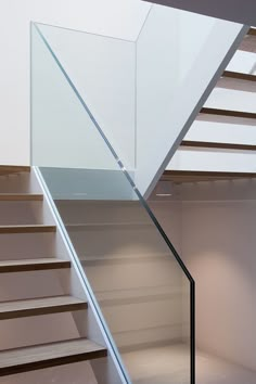 an empty staircase with glass steps leading up to the second floor