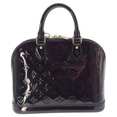 Elevate your style with the Louis Vuitton Monogram Vernis Alma PM bag. Handcrafted in France with burgundy colored patent leather and gold-tone hardware, it exudes sophistication and luxury. With a spacious interior and protective studs at the base, this bag combines practicality with elegance. Includes an Entrupy certificate of authenticity for peace of mind. Retail $2,350. Designer: Louis Vuitton Material: Monogram Vernis Patent Leather Color: Amarante Origin: France Date/Authenticity Code: FL Louis Vuitton Store, Louis Vuitton Vintage, Alma Pm, Sunglasses Logo, Lv Monogram, Chanel Vintage, Louis Vuitton Damier Ebene, Louis Vuitton Shoulder Bag, Vintage Louis Vuitton