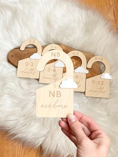 personalized wooden baby's name and birth date magnets on a white rug