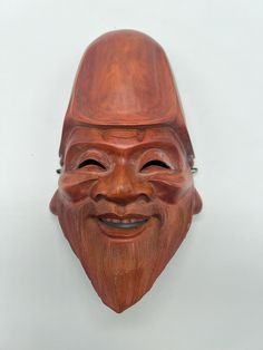 a wooden mask with a man's face on it