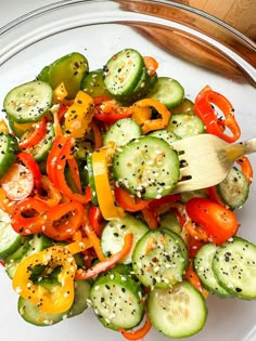 a white plate topped with cucumber, peppers and pepper mixed in seasoning