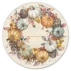 a wreath with pumpkins, leaves and acorns is on a white background