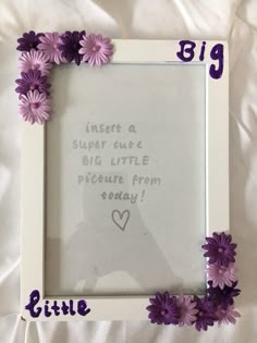 a white frame with purple flowers on it and the words little sister written in cursive writing