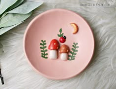 a pink plate topped with two mushrooms and a lady bug