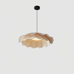 a light that is hanging from the ceiling in front of a white wall and floor