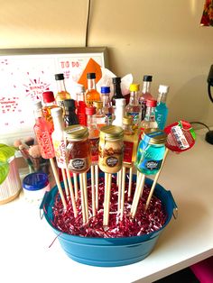 a blue bucket filled with lots of different types of condiments on top of a table