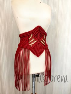 a mannequin with a red scarf on it's neck and fringes