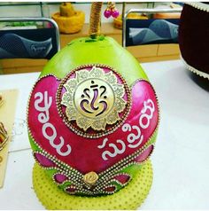 an ornately decorated pomegranate sits on a table