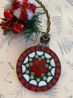 a stained glass ornament hanging from a christmas tree