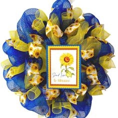 a blue and yellow mesh wreath with a sunflower on it