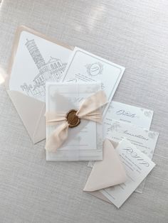 the wedding stationery is laid out on the table