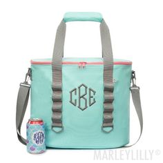 a cooler bag with the initials on it and a can of soda next to it