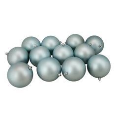 a pile of blue christmas balls on a white background