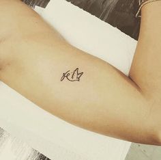 a person with a small tattoo on their arm that reads kev and has the letter k in it