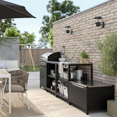 an outdoor bbq and patio furniture set up on the side of a brick wall