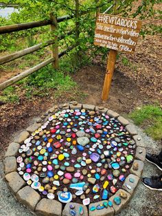 there is a sign that has been made out of rocks and stones in the shape of hearts