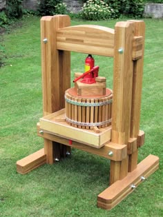 a wooden bench with a bucket on it and a red fire extinguisher in the back