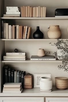 books, vases and other items are on the shelves