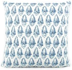 a blue and white pillow with leaves on it