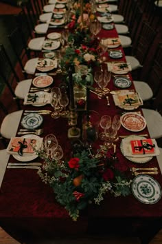 a long table is set with plates and place settings