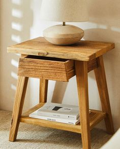 a wooden table with a lamp on top