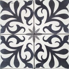 some black and white tiles with swirl designs on the bottom, one has an ornate design