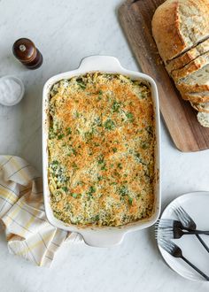 a casserole dish with bread on the side