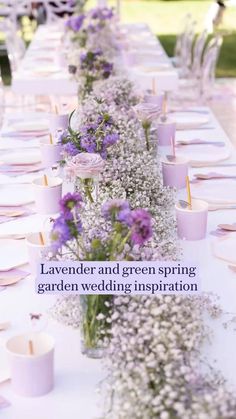 a long table with flowers and candles on it