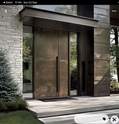 the front door of a modern home with glass doors