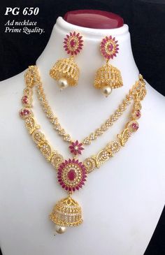 a necklace and earring set with pearls, rubs and beads on a mannequin