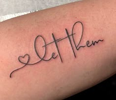 a woman's arm with the word love written in cursive writing